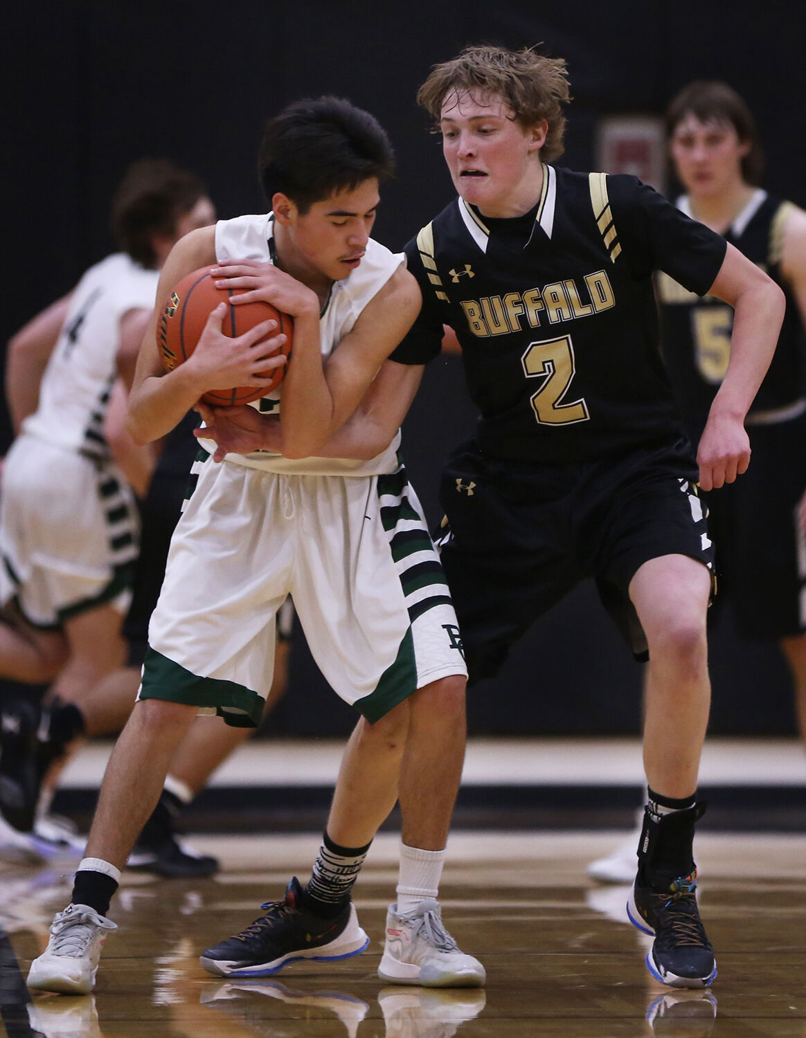 Coy Johnson reaches around Billings Central senior Clarence Stewart